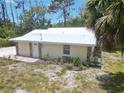 Newly remodeled single story home with metal roof and stone accents at 1136 Davis Ln, Englewood, FL 34224