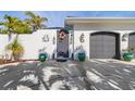 Front entrance with decorative door and two large planters at 1454 Kiwi Ct, Punta Gorda, FL 33950