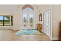 Bright foyer with decorative glass double doors, hardwood floors, and high ceilings at 1701 Casey Key Dr, Punta Gorda, FL 33950