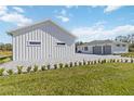 View of a two-car attached garage with brick driveway and landscape at 2154 Azure Rd, North Port, FL 34286