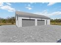 Exterior view of a two-car attached garage with brick driveway at 2154 Azure Rd, North Port, FL 34286