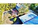 Relaxing backyard oasis with pergola and tropical landscaping at 22398 Walton Ave, Port Charlotte, FL 33952
