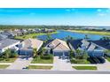 Aerial view of homes near a lake and golf course at 25228 Longmeadow Dr, Punta Gorda, FL 33955