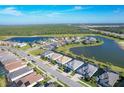 Aerial view of a luxury community with lake and golf course at 25228 Longmeadow Dr, Punta Gorda, FL 33955