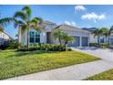 Single-Gathering home with gray exterior and landscaping at 25228 Longmeadow Dr, Punta Gorda, FL 33955