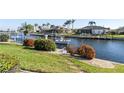 Relaxing view of canal with boat and lush landscaping at 2807 Sancho Panza Ct, Punta Gorda, FL 33950