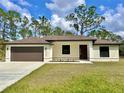 Newly constructed single-story home with a brown garage door and landscaped lawn at 2920 Barry Rd, North Port, FL 34286