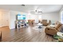 Bright living room featuring leather sofas and a large flat-screen TV at 325 San Benito Ave, North Port, FL 34287