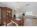 Dining area with chandelier, hardwood floors, and built-in hutch at 334 Skylark Nw Ln, Port Charlotte, FL 33952
