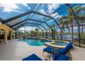 Relaxing screened-in pool and spa area overlooking the waterfront, perfect for entertaining and leisure at 3507 Marsala Ct, Punta Gorda, FL 33950