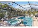 Relaxing screened-in pool and spa area with plenty of room for lounging at 351 S Mccall Rd, Englewood, FL 34223