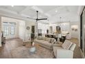 Open-concept living area with hardwood floors, neutral color palette, and ample natural light at 3800 Carupano Ct, Punta Gorda, FL 33950