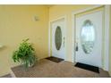 Front entry with double doors, tile flooring, and potted plant at 4410 Warren Ave # 504, Port Charlotte, FL 33953