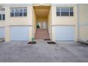 Townhouse entry with stairs leading to double doors and garages at 4410 Warren Ave # 504, Port Charlotte, FL 33953