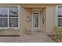 Front entry with decorative wall art and a brick walkway at 4590 Turnberry Cir, North Port, FL 34288