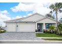 Two-story home with a three-car garage and attractive landscaping at 12717 Morning Mist Pl, Venice, FL 34293
