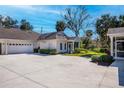 Charming one-story home with a well-maintained lawn, a spacious driveway, and an attached garage at 1407 Red Oak Ln, Port Charlotte, FL 33948