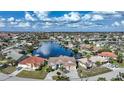 Bird's-eye view of waterfront home in a community with many canals and boats at 1412 Sea Fan Dr, Punta Gorda, FL 33950