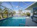 Inviting screened pool with canal views and a grill at 1412 Sea Fan Dr, Punta Gorda, FL 33950