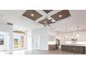 Open living space with high ceilings, coffered accents, and hardwood floors at 16920 Ohara Dr, Port Charlotte, FL 33948