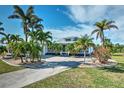 White house with palm trees, driveway, and landscaped lawn at 17455 Boca Vista Rd, Punta Gorda, FL 33955