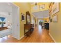 Bright hallway with hardwood floors and decorative mirror at 17455 Boca Vista Rd, Punta Gorda, FL 33955