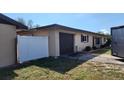 Exterior features of the property, including an attached garage and a white privacy fence at 181 Coconut St, Punta Gorda, FL 33980