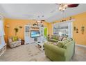 Spacious living room with comfy sofas, large TV, and bright walls at 20 Medalist Cir, Rotonda West, FL 33947