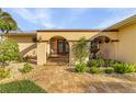 Front entry with arched walkway, fountain, and lush landscaping at 2198 El Cerito Ct, Punta Gorda, FL 33950