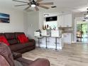 Open living room with kitchen island and modern flooring at 28301 N Twin Lakes Dr, Punta Gorda, FL 33955