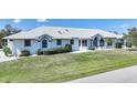 Lovely single-story home featuring a manicured lawn, neat landscaping, and a brightly painted exterior at 3339 Desoto Dr, Punta Gorda, FL 33983