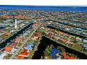 An aerial view showcasing the home's location on a canal with access to bay waters and the surrounding waterfront neighborhood at 400 Coronado Dr, Punta Gorda, FL 33950