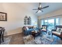 Comfortable living room featuring a ceiling fan, wood flooring, and a large window with beautiful views at 5738 Sabal Trace Dr # 204B57, North Port, FL 34287