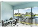 Relaxing screened-in patio with outdoor table and chairs overlooking the water fountain and lush green landscape at 5738 Sabal Trace Dr # 204B57, North Port, FL 34287