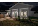 Craftsman style home at night with teal front door at 706 W Madison St, Plant City, FL 33563