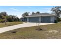 Charming single-story home featuring a three-car garage and well-maintained landscaping at 9 Logan St, Port Charlotte, FL 33954