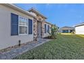 The home's front entrance features stone work, a brick paver path and professional landscaping at 16300 Coconut Palm Dr, Port Charlotte, FL 33953