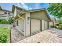 Attractive townhome exterior with two car garage, brick pavers and landscaping at 1710 Starling Dr # 102, Sarasota, FL 34231