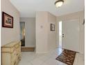 Bright foyer with neutral walls and white tile flooring at 1710 Starling Dr # 102, Sarasota, FL 34231