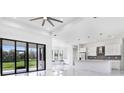 Modern kitchen with white cabinets, island, and stainless steel appliances at 17200 Mint Ln, Punta Gorda, FL 33955