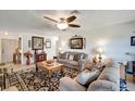 Cozy living room with plush sofas, decorative accents and a ceiling fan at 20352 Tappan Zee Dr, Port Charlotte, FL 33952