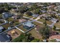 Aerial shot of a neighborhood featuring a home with a screened-in pool and fenced-in yard at 20431 Calder Ave, Port Charlotte, FL 33954