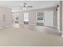 Bright living room with a ceiling fan, tile flooring, and neutral paint at 21274 Gladis Ave, Port Charlotte, FL 33952