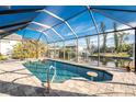 Relaxing screened-in pool area with inviting blue water and ample seating at 24343 Pirate Harbor Blvd, Punta Gorda, FL 33955