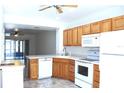 Galley kitchen with wood cabinets and appliances at 26376 Nadir Rd # 301, Punta Gorda, FL 33983