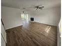 Spacious living room featuring hardwood floors and a fireplace at 3261 Mill Run Ct, North Port, FL 34287