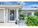 Front entrance featuring a decorative screen door and landscaping at 4059 Twinbush Ter, North Port, FL 34286