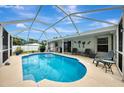 Relaxing screened-in pool area with patio furniture at 4059 Twinbush Ter, North Port, FL 34286