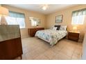 Bright bedroom featuring tiled floors, neutral walls, and comfortable furnishings at 4355 Boggs St, Port Charlotte, FL 33948