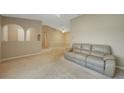 Light beige living room with a tan couch and view to kitchen at 4415 Mundella Cir, Port Charlotte, FL 33948